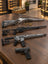 Sig Sauer P322, Marlin 1895 SBL, Tikka T3x ACE Target och Sig Sauer M400 DH3 på ett mörkt träbord i ett ljust showroom.